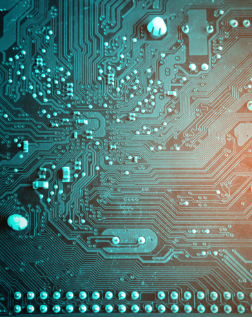 Close-up of a circuit board with teal traces and components.