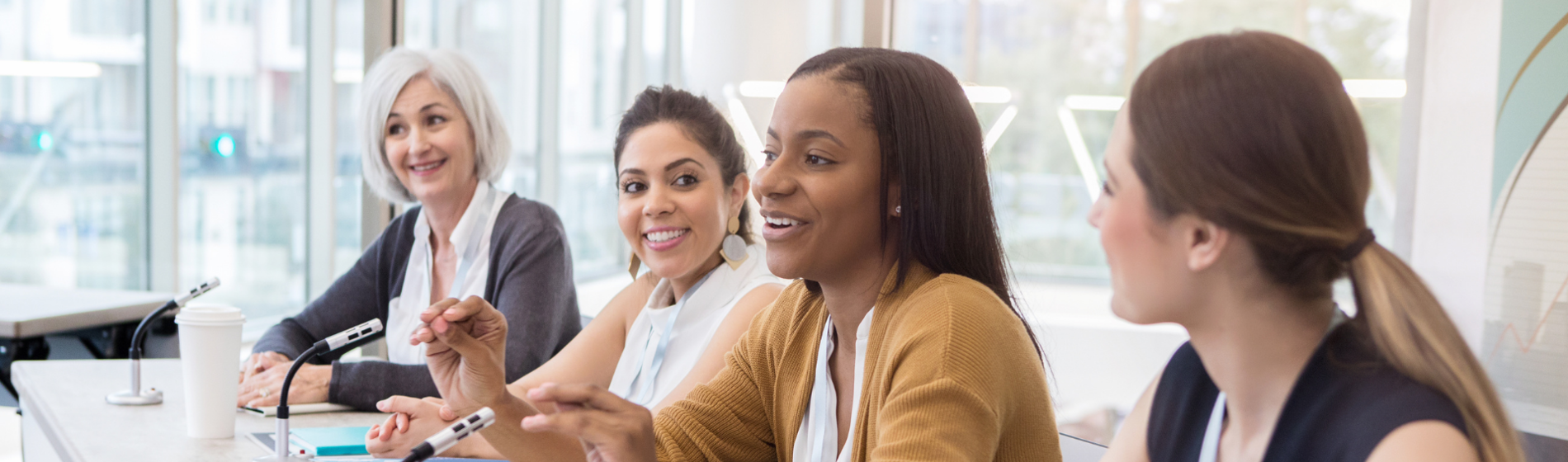 A group of female professionals talking at a panel